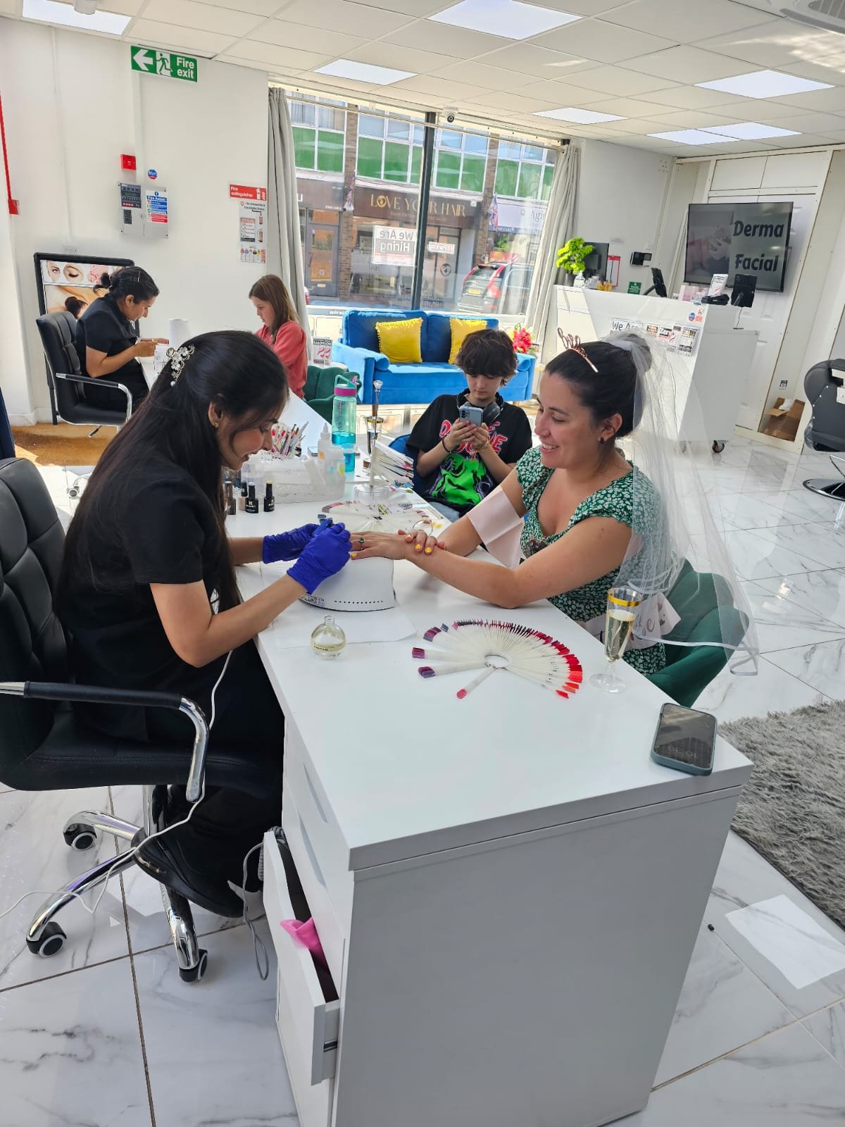 Smiling bride-to-be wearing a sash and enjoying her special day of pampering during her hen party at Seema’s Beauty Salon